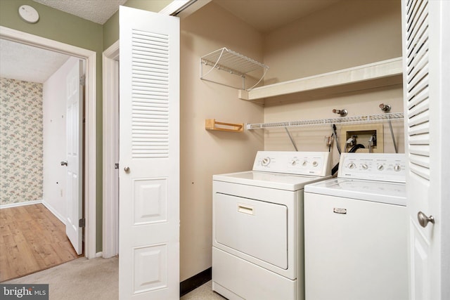 laundry area with laundry area, wallpapered walls, baseboards, and washer and dryer