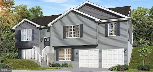 split foyer home featuring a garage and a front yard