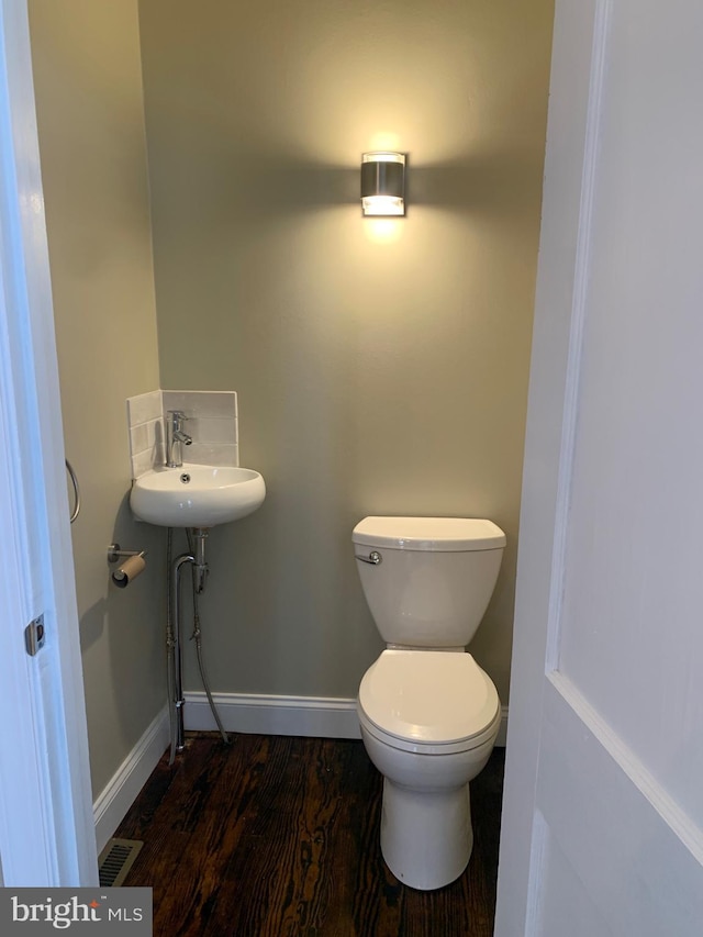 bathroom with sink, hardwood / wood-style flooring, and toilet