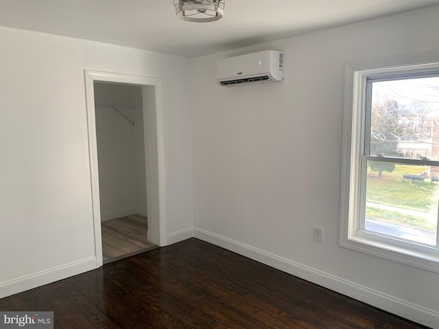 interior space featuring dark hardwood / wood-style floors and an AC wall unit