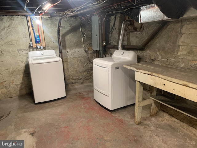 basement with electric panel and independent washer and dryer