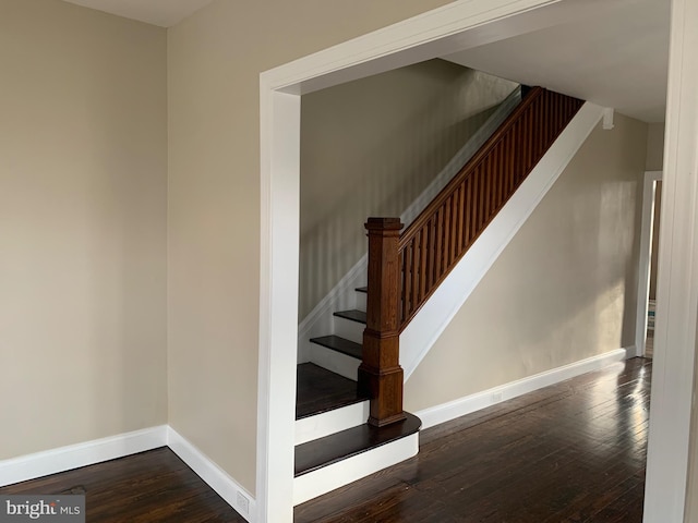 stairway featuring wood-type flooring