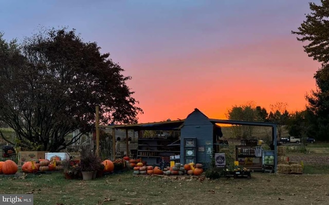 outdoor structure at dusk with a yard