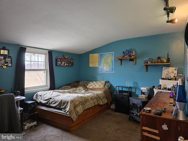 bedroom featuring lofted ceiling and carpet