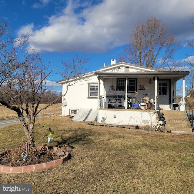 view of front of home with a front yard and a porch