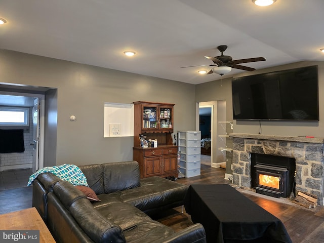 living room featuring ceiling fan, dark wood-type flooring, and a fireplace