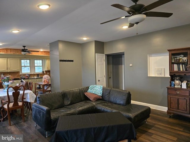 living room featuring dark hardwood / wood-style flooring and ceiling fan