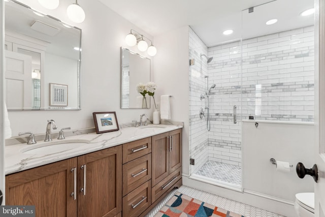 bathroom with toilet, vanity, tile patterned floors, and walk in shower