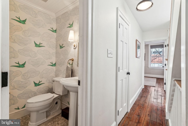 bathroom with hardwood / wood-style flooring, ornamental molding, and toilet