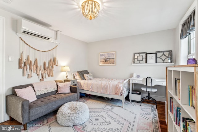 bedroom featuring hardwood / wood-style floors and a wall mounted air conditioner