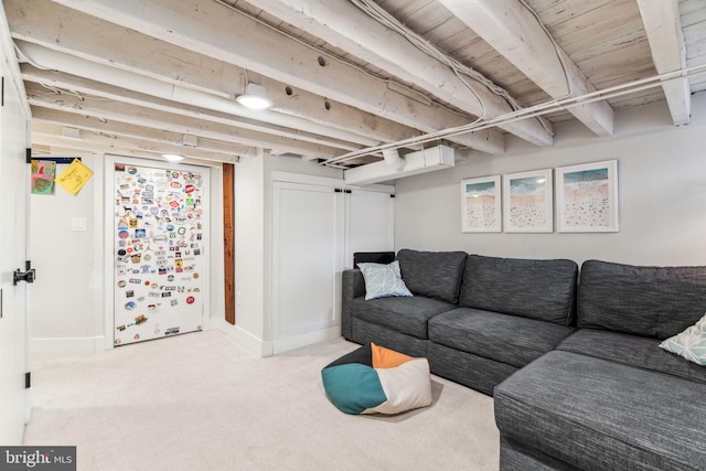 living room with beam ceiling and light colored carpet