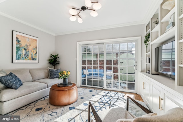 living room featuring crown molding and a chandelier