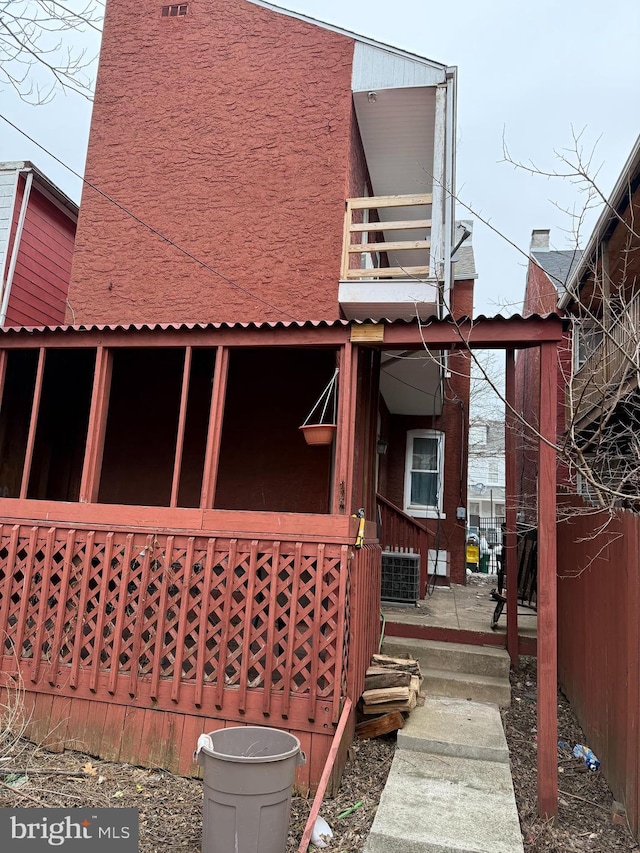 back of house with central AC and a balcony