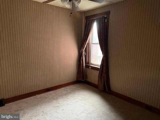 unfurnished room featuring carpet and ceiling fan