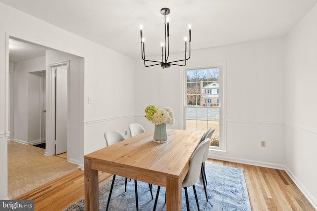 dining room featuring an inviting chandelier and light hardwood / wood-style floors