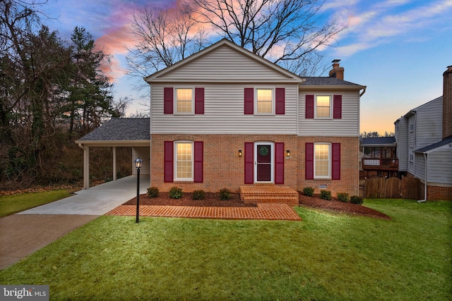 view of property featuring a carport and a lawn