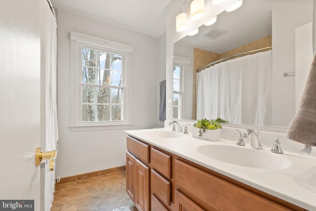 bathroom featuring tile patterned flooring and vanity