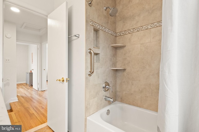 bathroom featuring hardwood / wood-style flooring and shower / bath combo