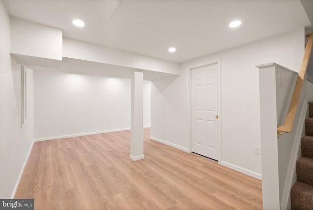 basement with light hardwood / wood-style floors