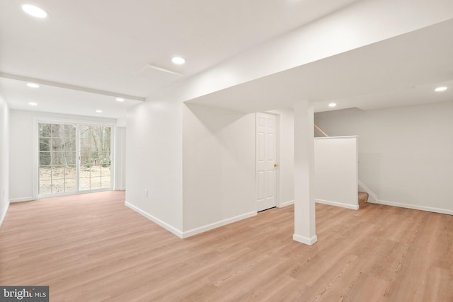 basement with light hardwood / wood-style flooring