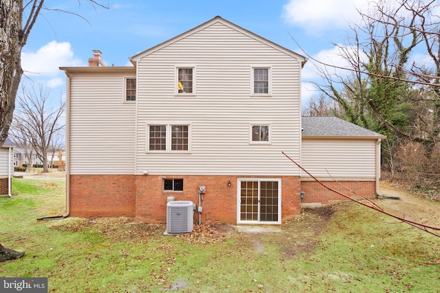 rear view of house featuring a yard and central air condition unit