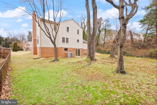 view of property exterior with central AC unit and a lawn