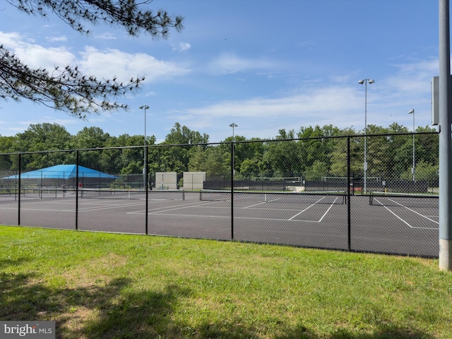 view of sport court featuring a yard