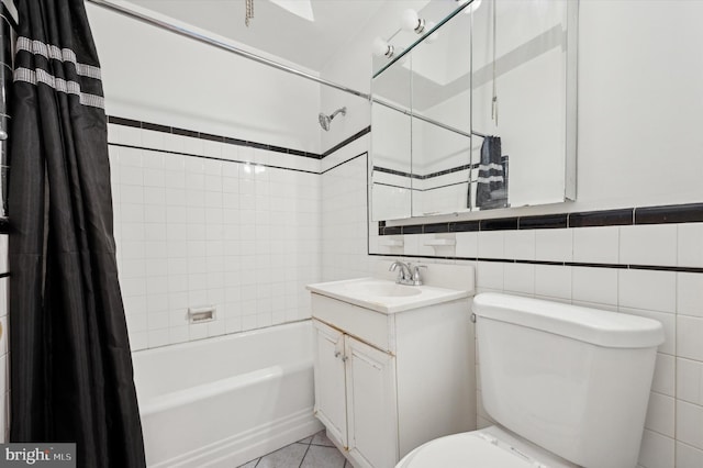 full bathroom featuring tile walls, vanity, tile patterned floors, and shower / bathtub combination with curtain