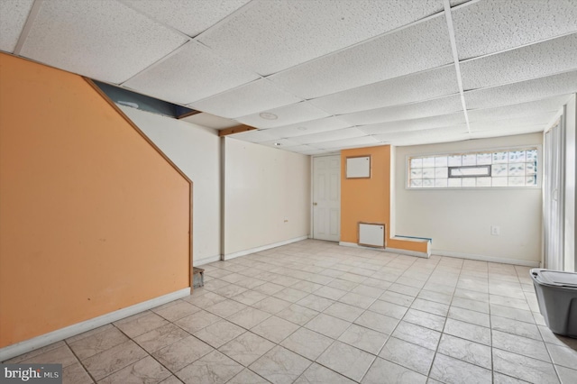 basement featuring a drop ceiling