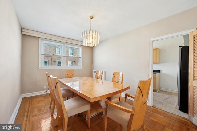 dining room featuring an inviting chandelier and light parquet floors