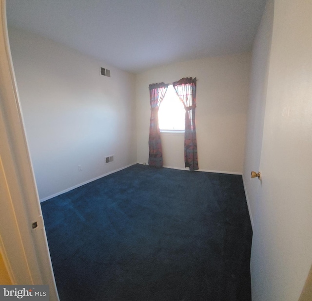 carpeted spare room with visible vents