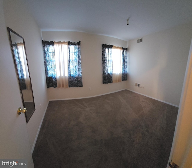 carpeted empty room featuring visible vents and baseboards