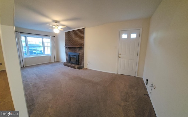 unfurnished living room with a brick fireplace, carpet, baseboards, and a ceiling fan