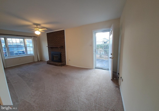 unfurnished living room featuring carpet floors, a fireplace, baseboards, and ceiling fan