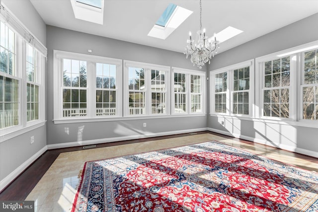 sunroom with lofted ceiling and an inviting chandelier