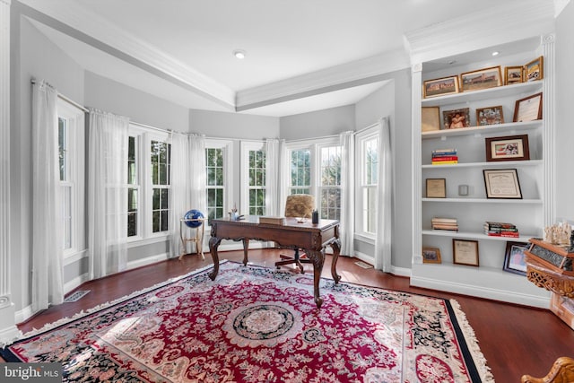 office space featuring a tray ceiling, baseboards, ornamental molding, and wood finished floors