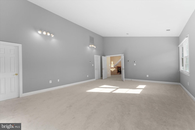 unfurnished room featuring light colored carpet, visible vents, and baseboards