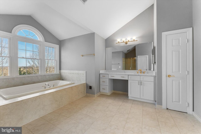 full bathroom with vaulted ceiling, visible vents, a garden tub, and vanity