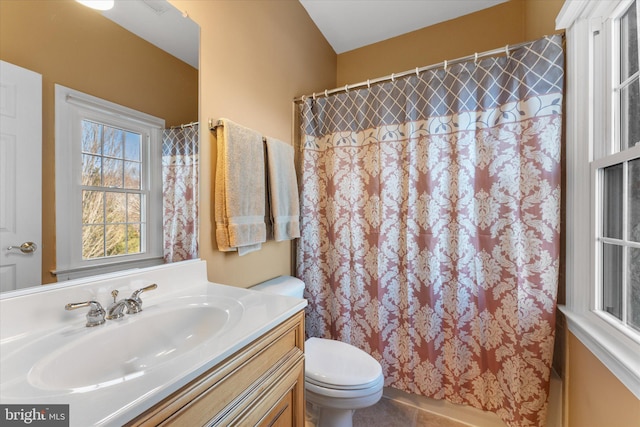 bathroom featuring toilet, a shower with curtain, tile patterned floors, and vanity