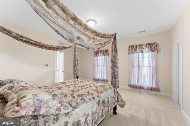 carpeted bedroom featuring visible vents and baseboards