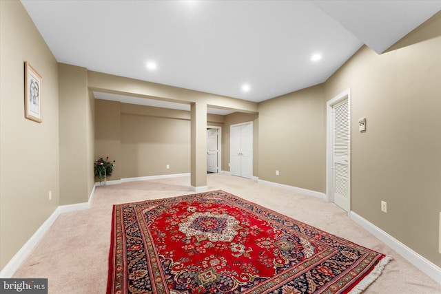 finished basement with recessed lighting, light carpet, and baseboards