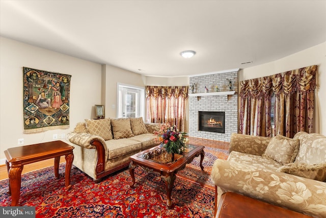 living area featuring a fireplace and wood finished floors