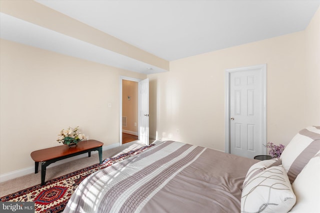 bedroom with carpet, visible vents, and baseboards