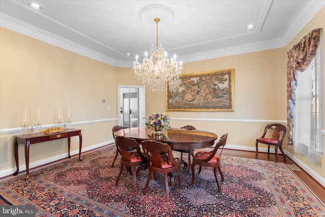 dining space featuring baseboards, a chandelier, crown molding, and recessed lighting