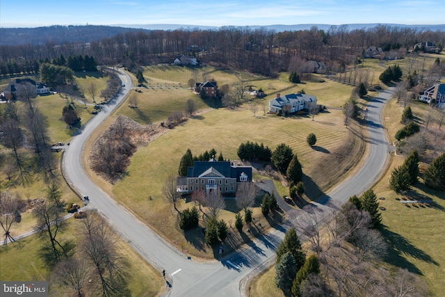 aerial view with a rural view and a wooded view