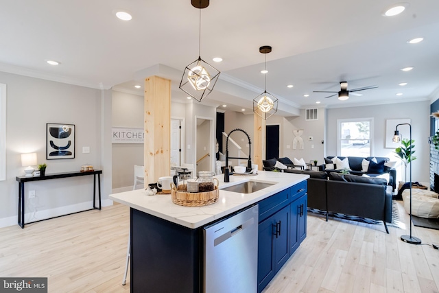 kitchen featuring pendant lighting, dishwasher, sink, ornamental molding, and a kitchen island with sink