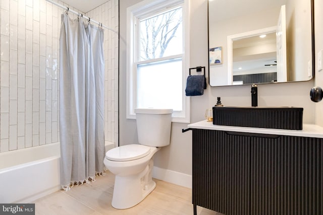 full bathroom featuring shower / tub combo, vanity, and toilet