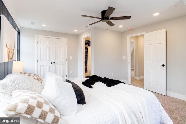 carpeted bedroom featuring ceiling fan and a closet