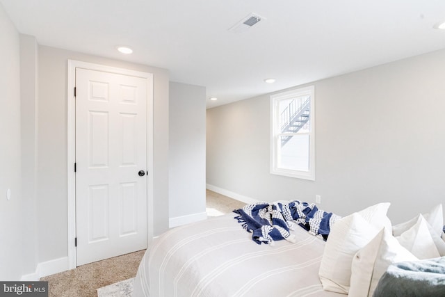 bedroom with light colored carpet