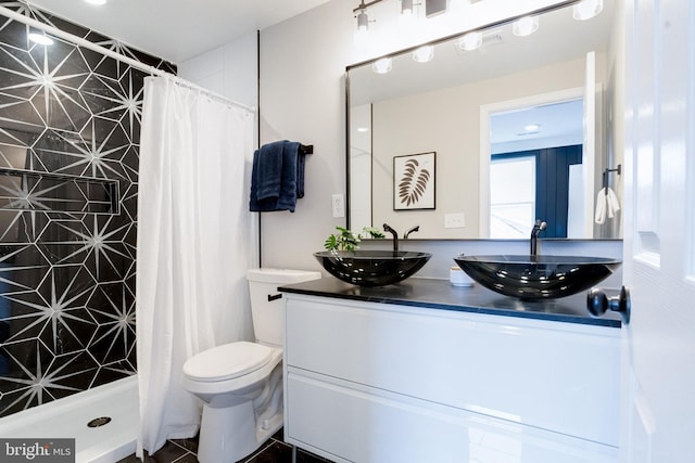 bathroom featuring vanity, a shower with curtain, and toilet